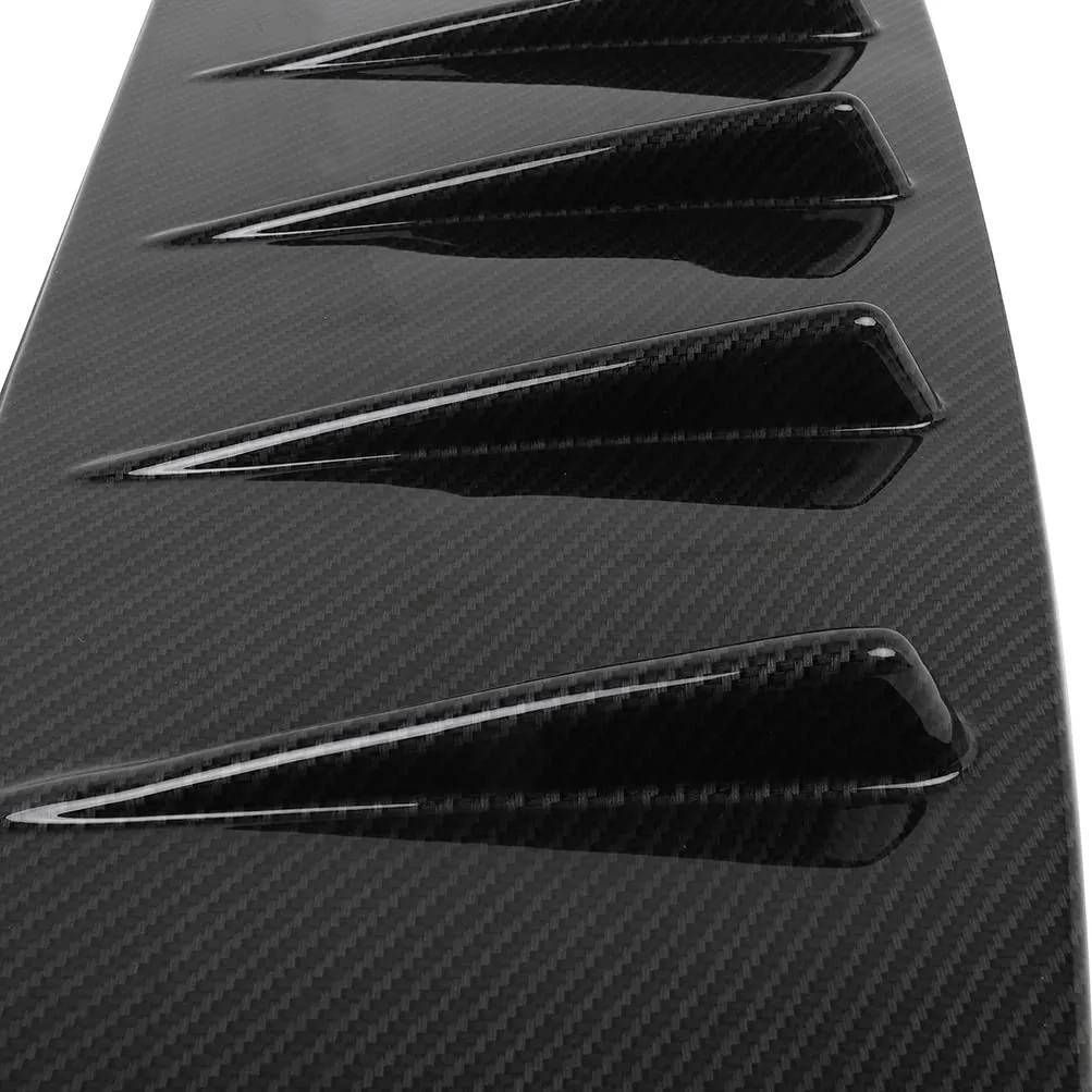 Close-up of a glossy carbon-look rear window louver with angled fins